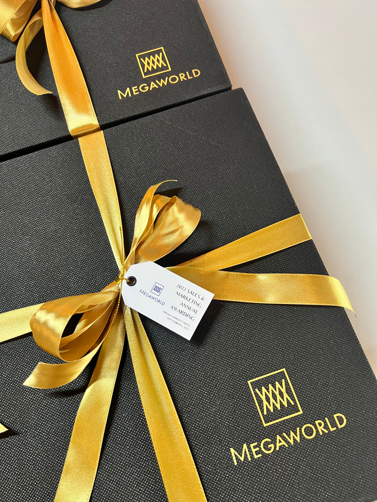 Megaworld gift boxes tied with gold ribbon